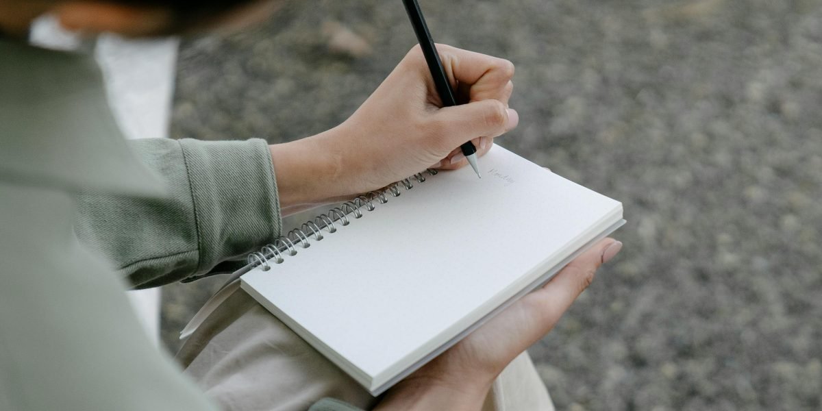 A person confidently taking notes, symbolizing the mastery of new search techniques for better book discovery.