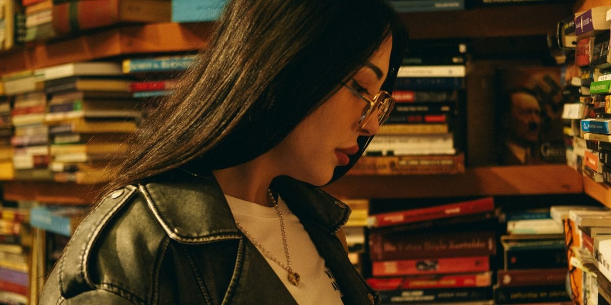 An adult reader contemplates a library shelf, searching for stories with real depth and lasting impact.