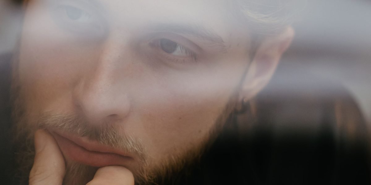 A person deep in thought, reflecting on the challenging moral dilemmas often presented in dark fantasy.