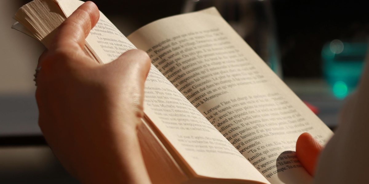 A person deeply engrossed in reading a book, reflecting the immersive nature of powerful literature.