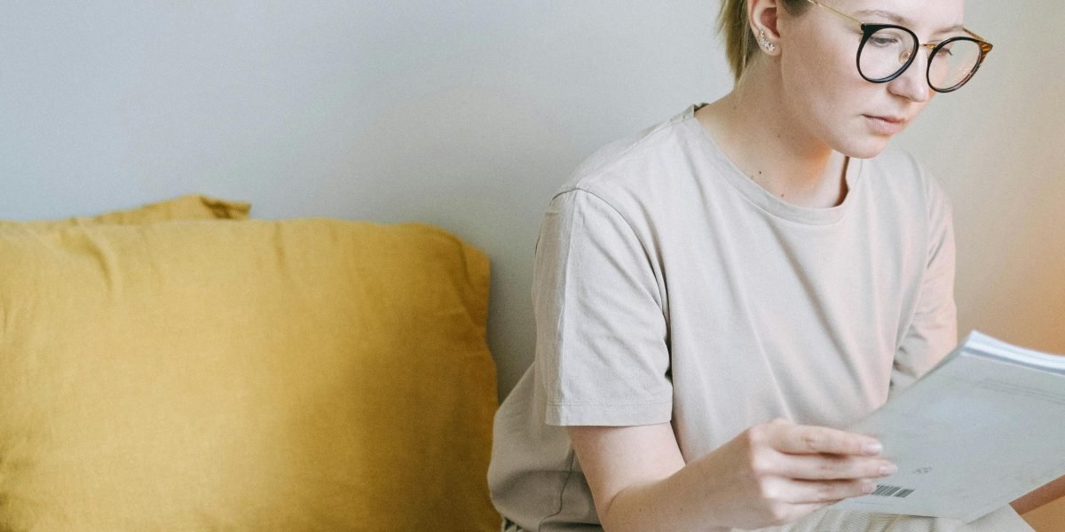 A person deeply focused on reading an e-reader in a quiet, comfortable setting, emphasizing the immersive experience.