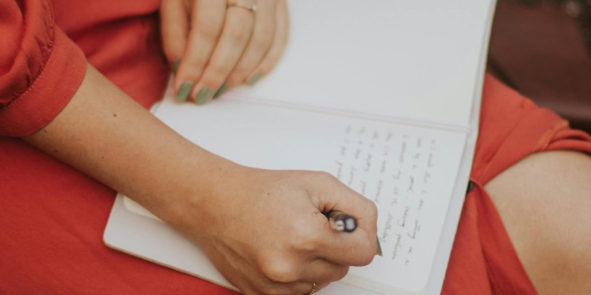 A person using a stylus to write notes on a tablet, illustrating active engagement and organization of thoughts.