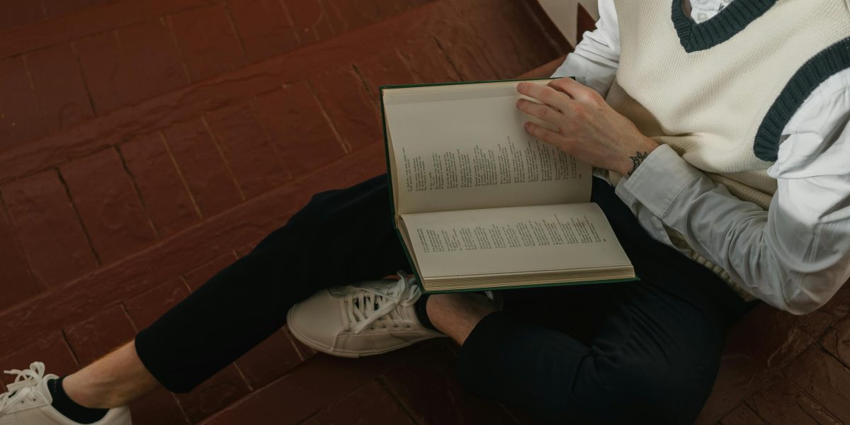 A reader engrossed in an adult fantasy book, highlighting the immersive experience.